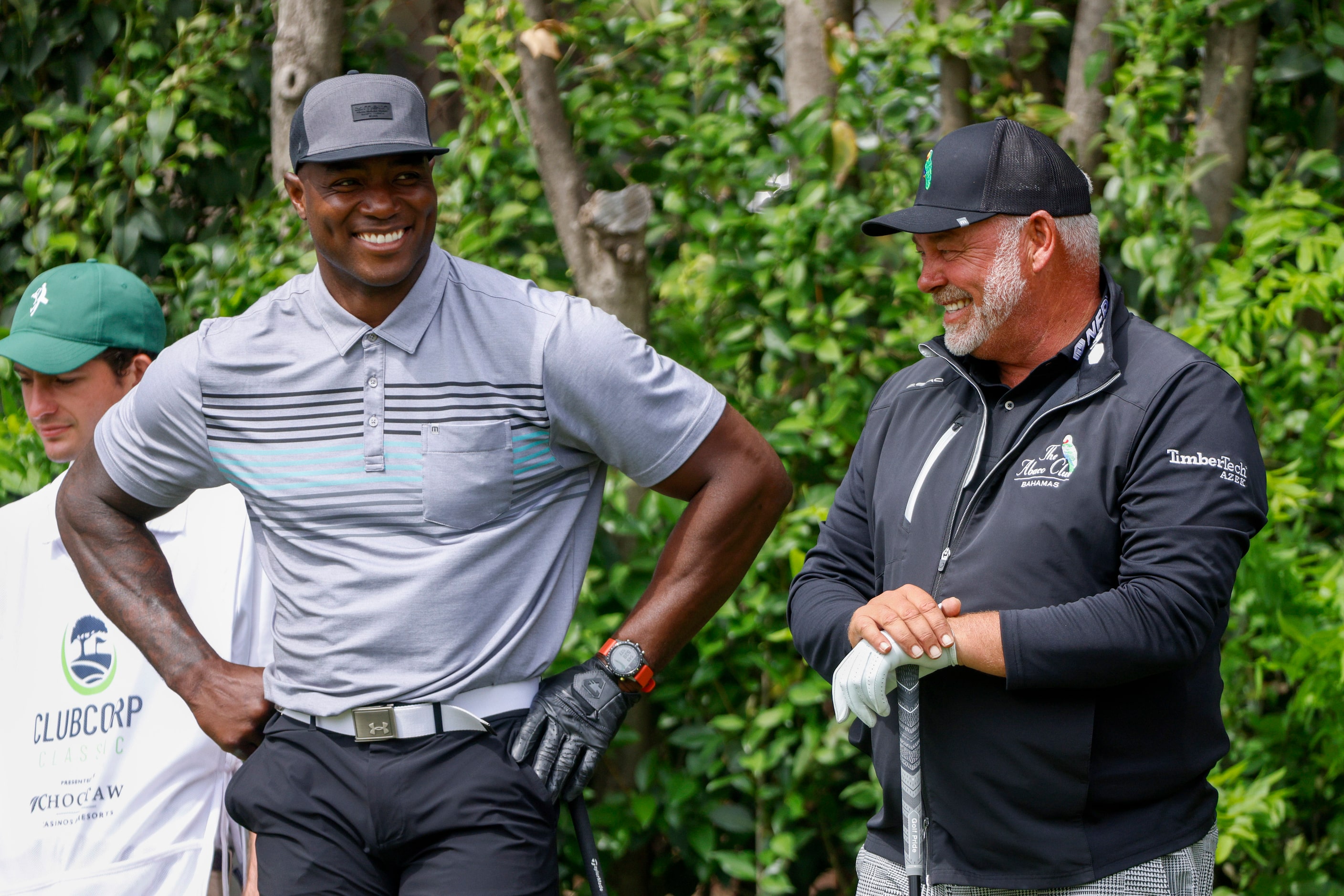 Former Dallas Cowboys player DeMarcus Ware (left) laughs with professional golfer Darren...