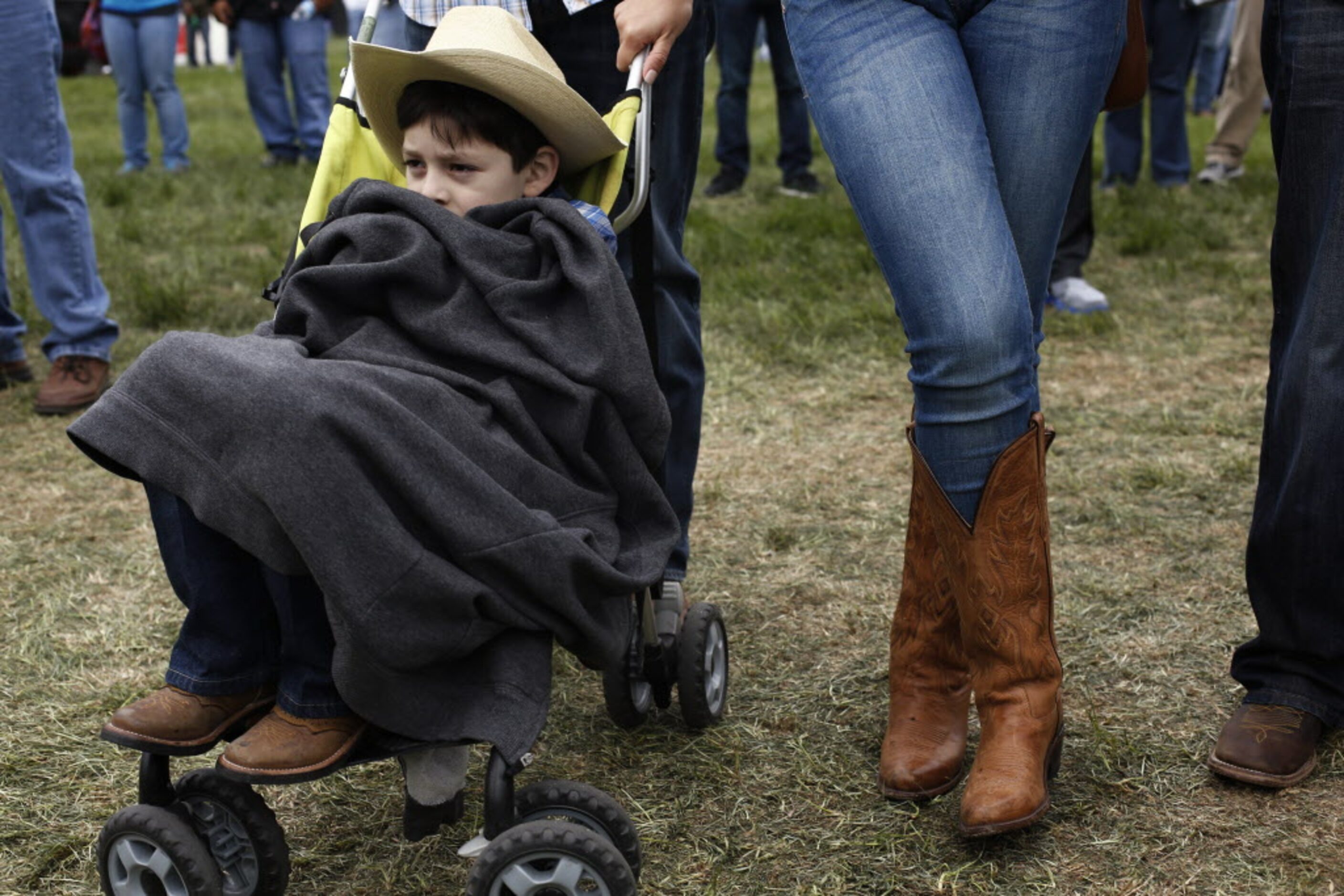 Anthony Estrello, 5, bundles up in a stroller during the March Madness Music Festival at...