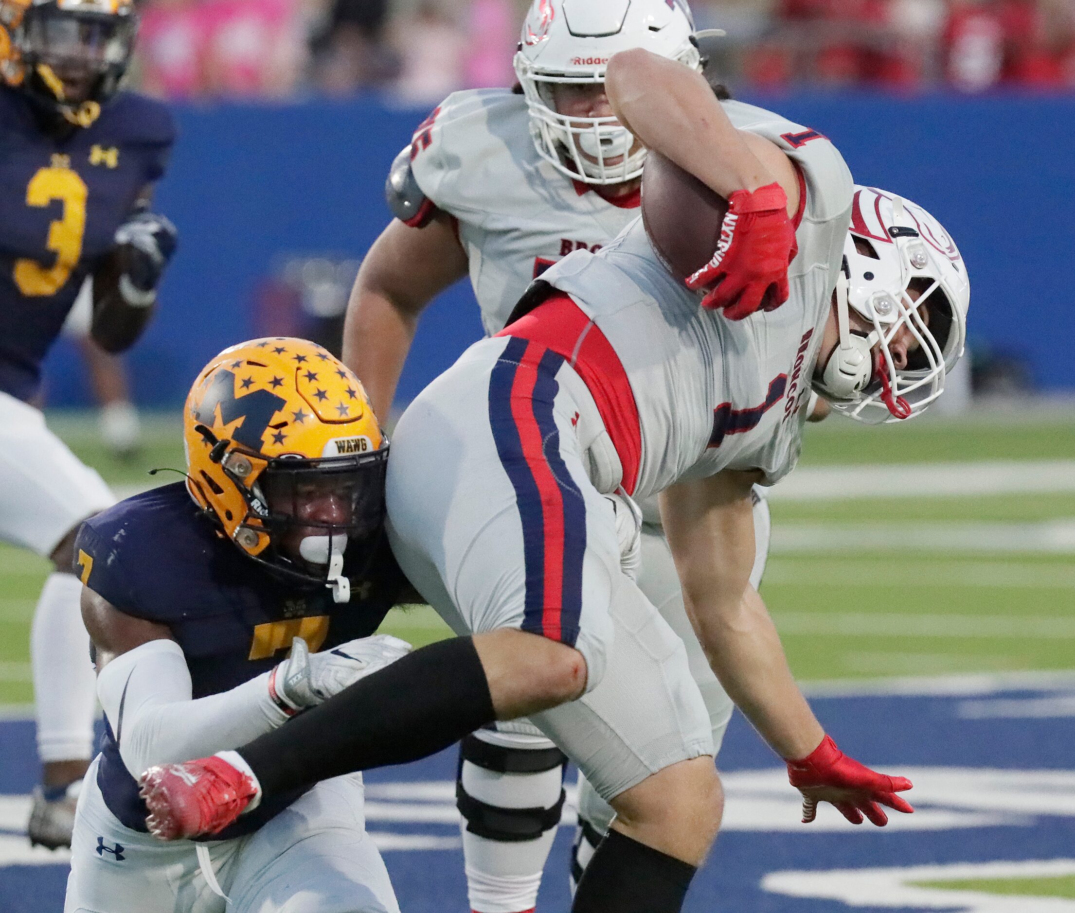 McKinney Boyd High School wide receiver Hayden Jenkins (1) is tackled by McKinney High...