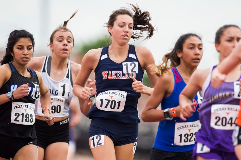 Frisco Wakeland's Isabella West (center) runs the High School Girls 1600 Meter race during...