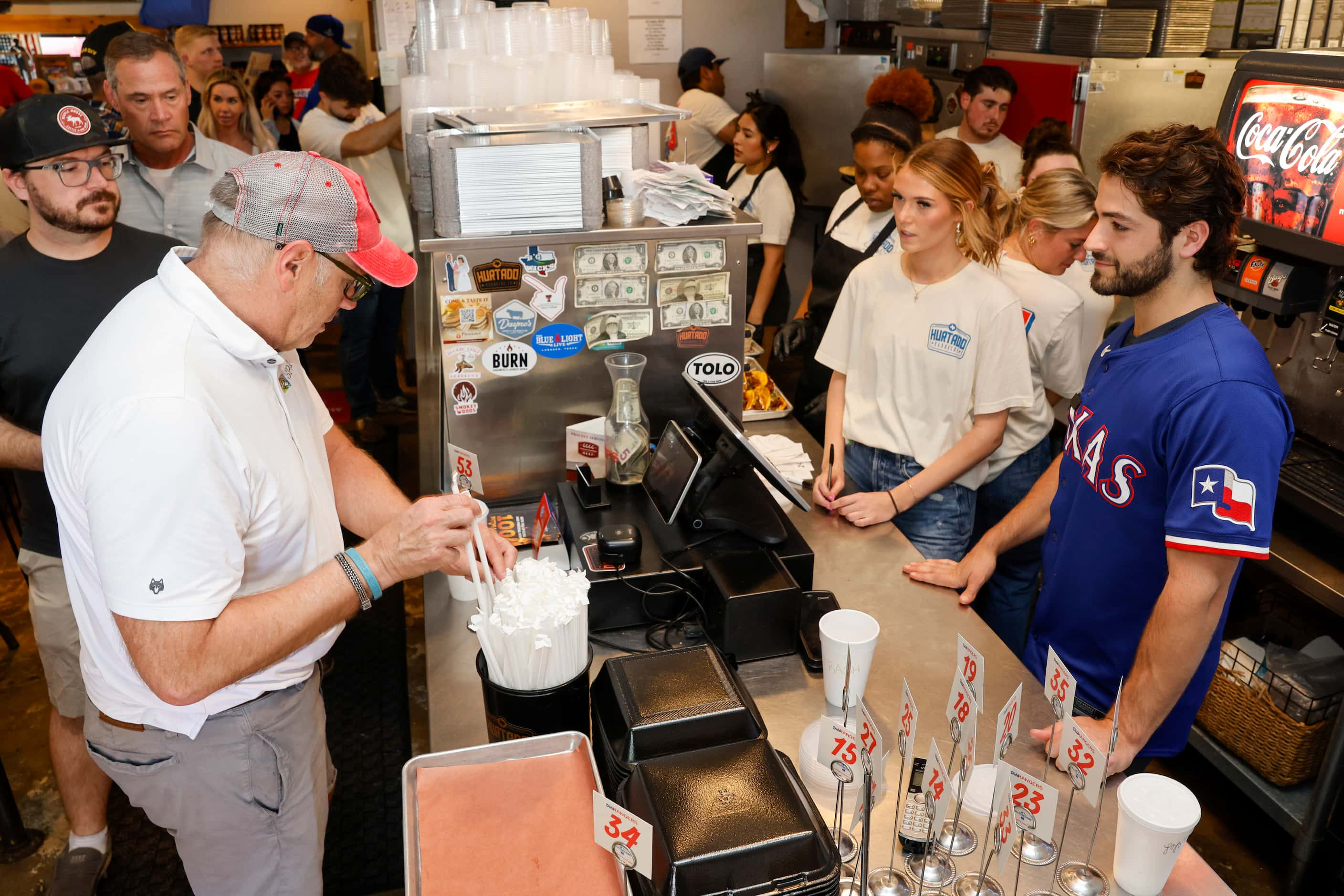 Texas Rangers third baseman Josh Smith runs the register at Hurtado Barbecue, Friday, June...