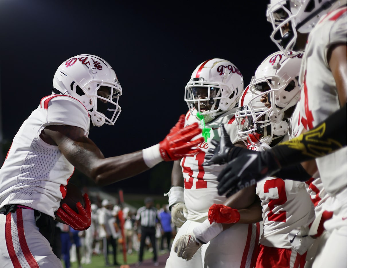 Duncanville receiver Zach Turner (9), left, celebrates with teammates in the end zone after...