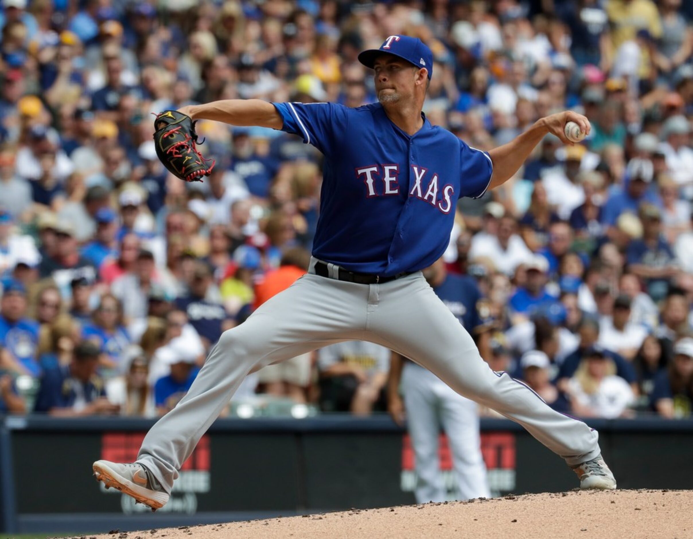 Texas Rangers starting pitcher Mike Minor throws during the first inning of a baseball game...