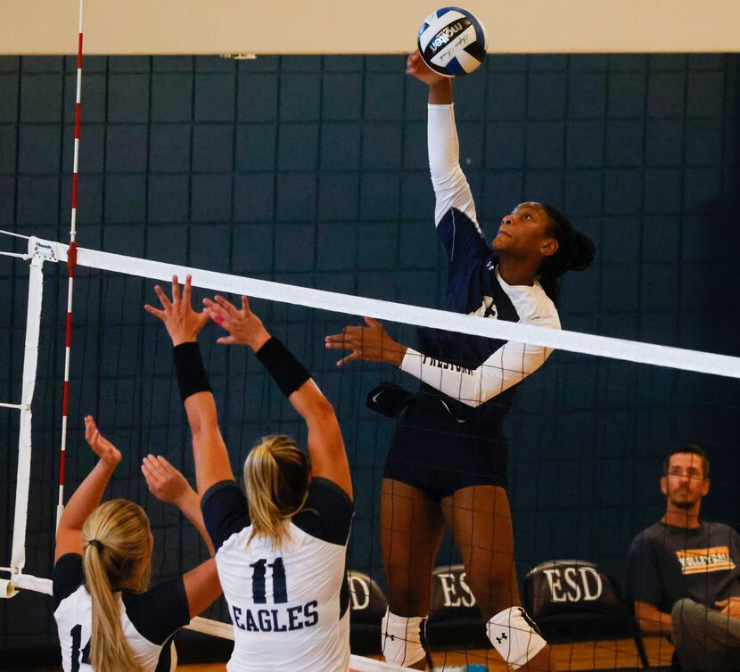 Prestonwood Christian Academy’s Macaria Spears, right, digs the ball against Episcopal...