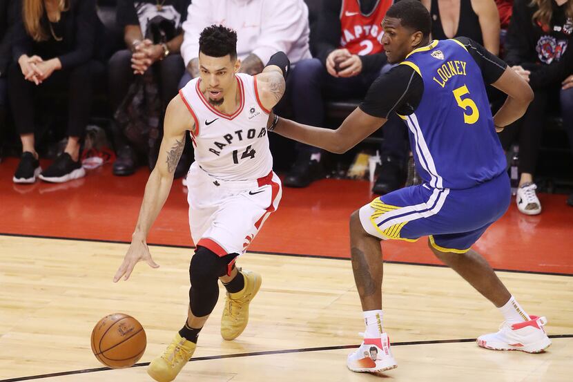 TORONTO, ONTARIO - JUNE 10:  Danny Green #14 of the Toronto Raptors is defended by Kevon...
