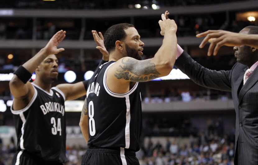 Brooklyn Nets guard Deron Williams (8)(center) celebrates with Paul Pierce (34) and the...