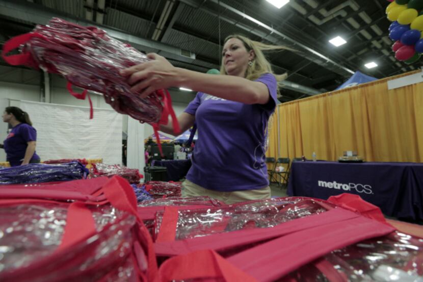 Laura Beyer stacks MetroPCS backpacks to be given out at the annual Mayor's Back to School...