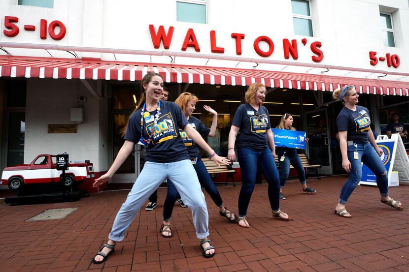 BENTONVILLE, AR - MAY 31: Walmart associates dance in front of Sam Walton's original 5 & 10...