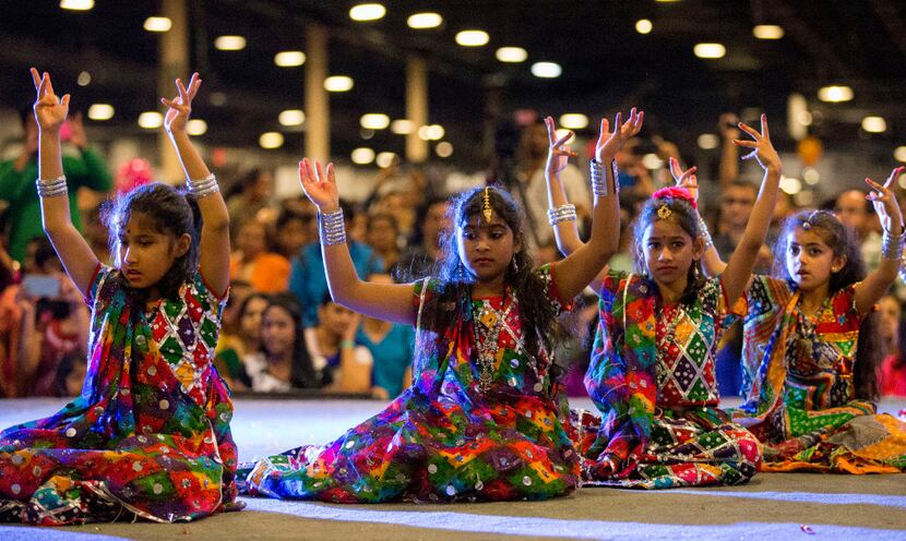 Children in dance teams perform onstage during Diwali Mela at Fair Park.