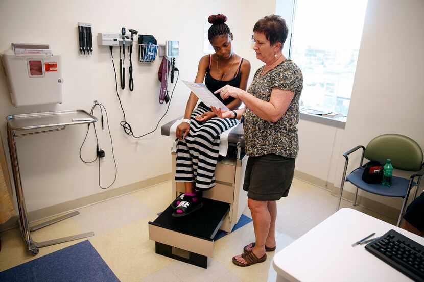 Kayjanet Moore, 18, has birth control options explained to her by social worker Cindy Covell...