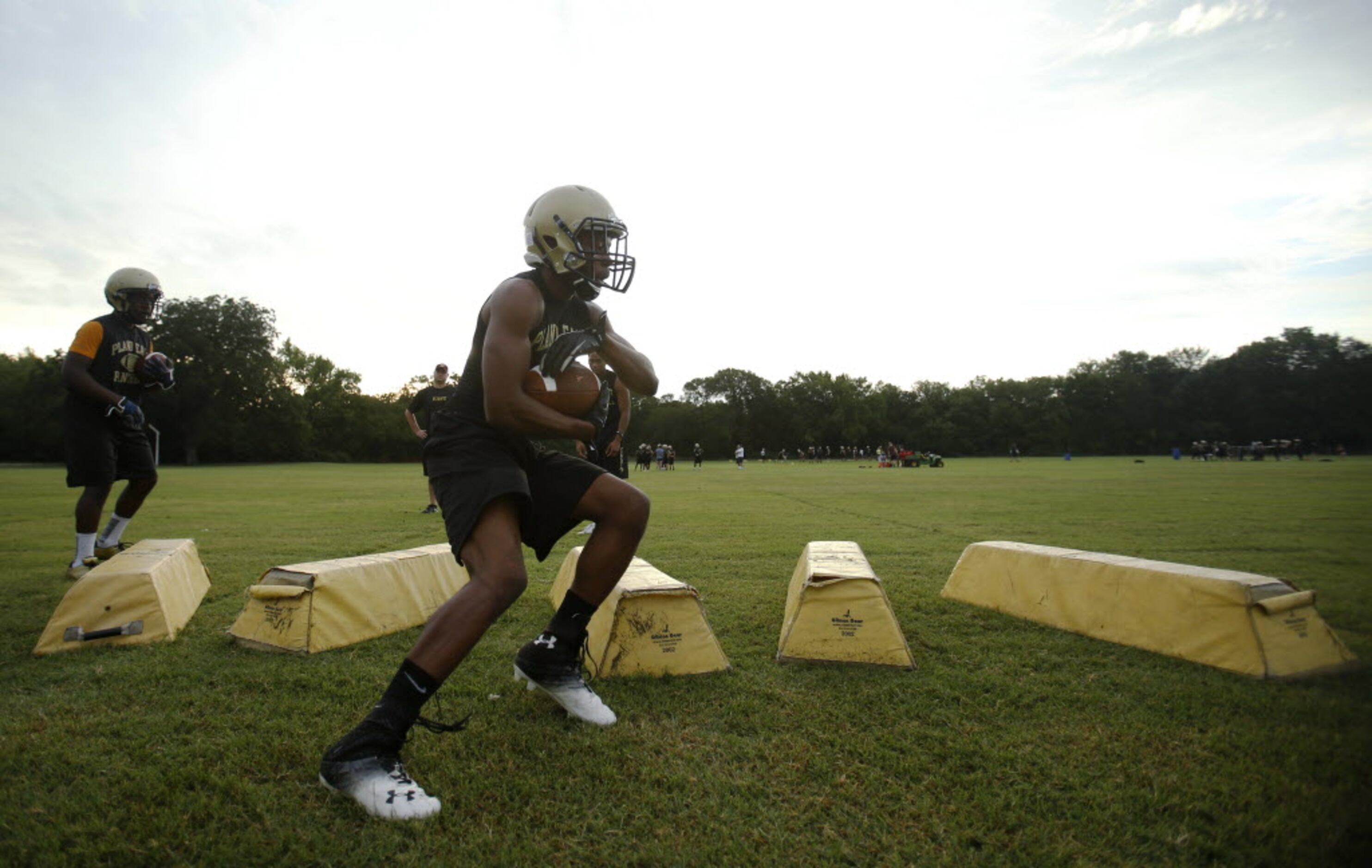 Plano East's running back Jaquawan Douglas runs through a drill during the first day of...