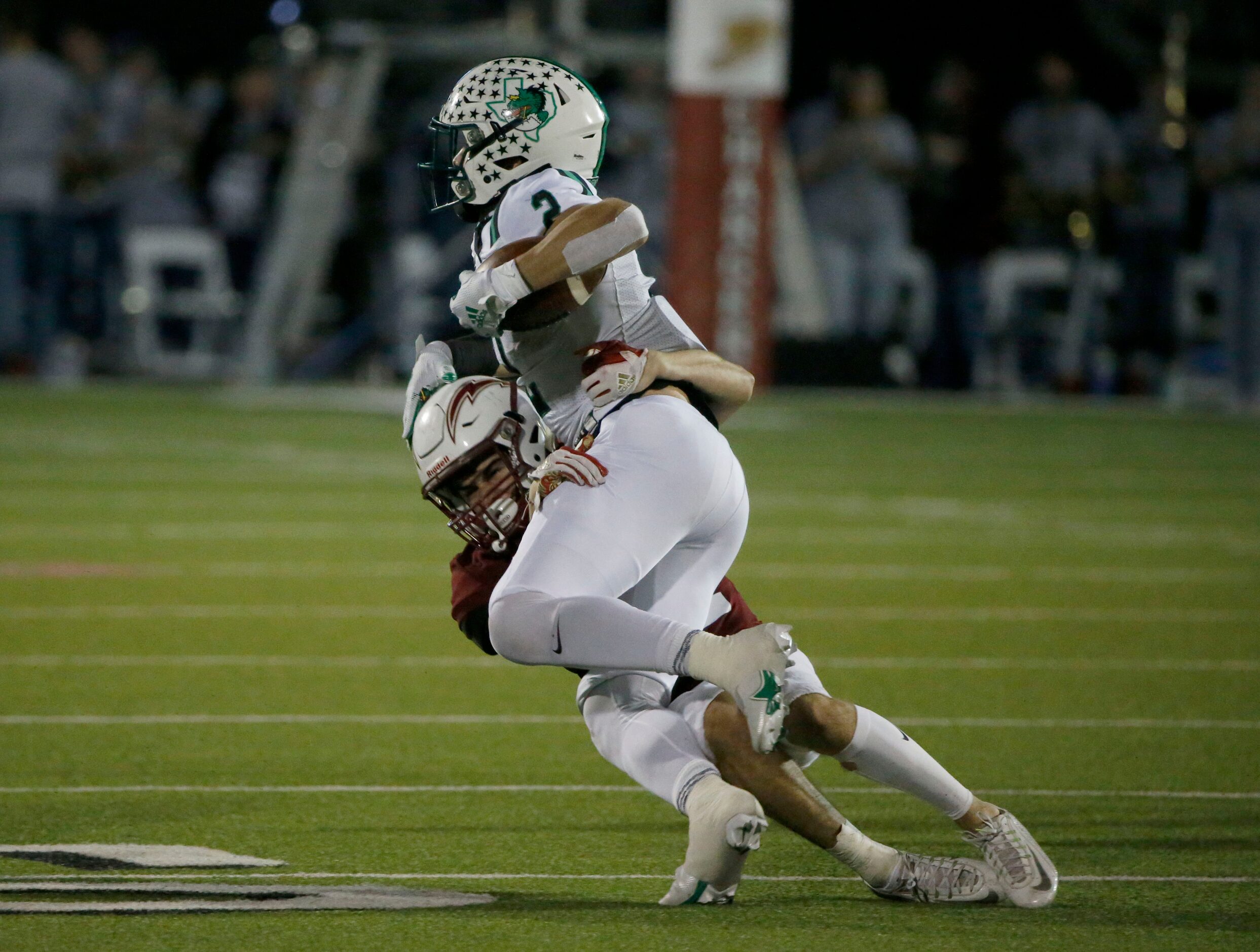 Southlake Carroll running back Owen Allen (2) is tackled by Keller Central’s Garrett Briscoe...