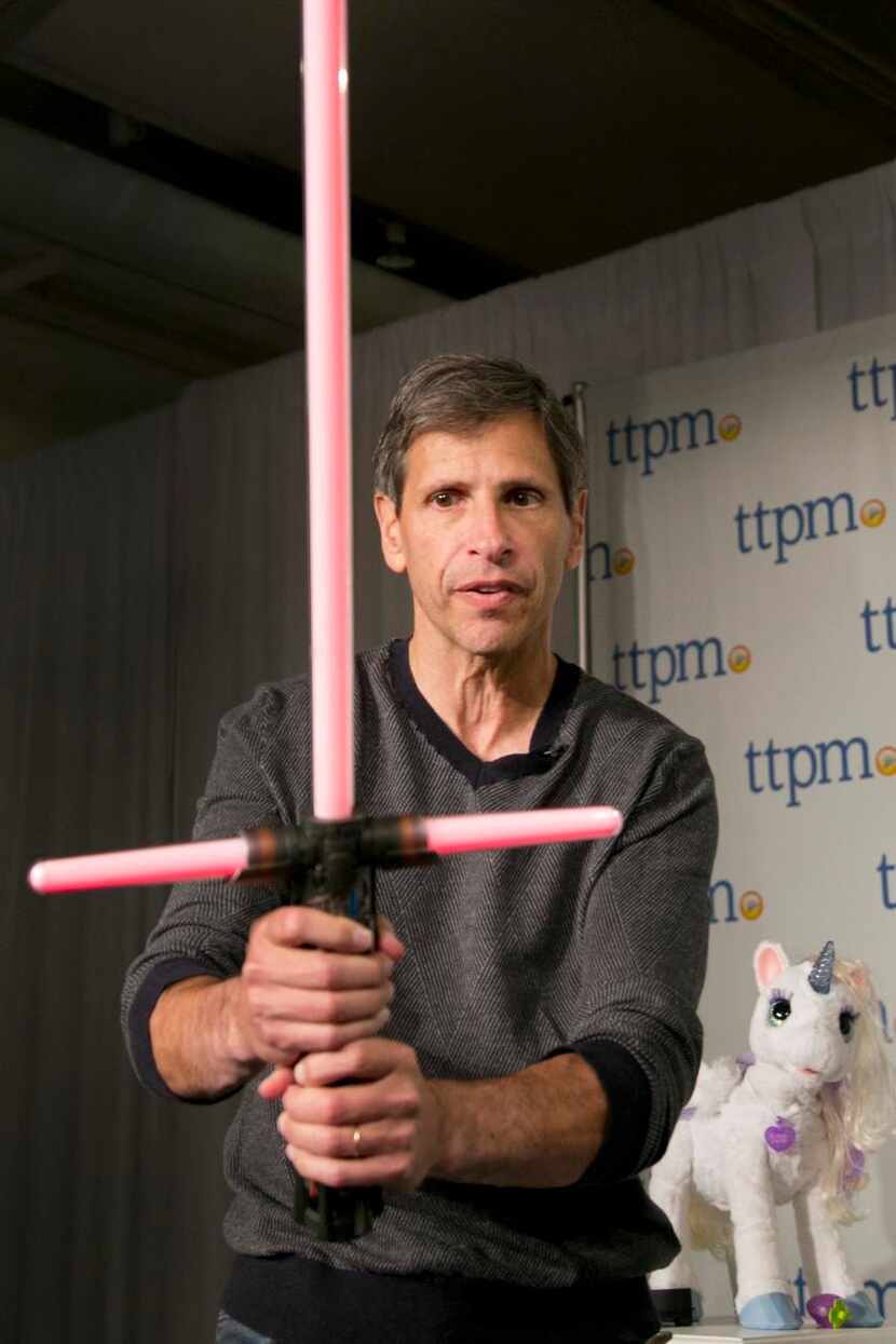 
Jim Silver of Toys, Tots, Pets & More wields a Kylo Ren Force FX Lightsaber.
