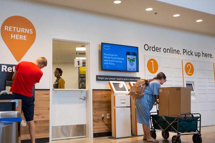 Customers visit the new Amazon Pickup and Return area inside the Whole Foods store in the...