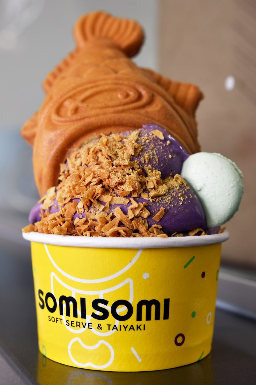 An upside down cone served in a cup with ube flavored soft serve from SomiSomi Soft Serve &...