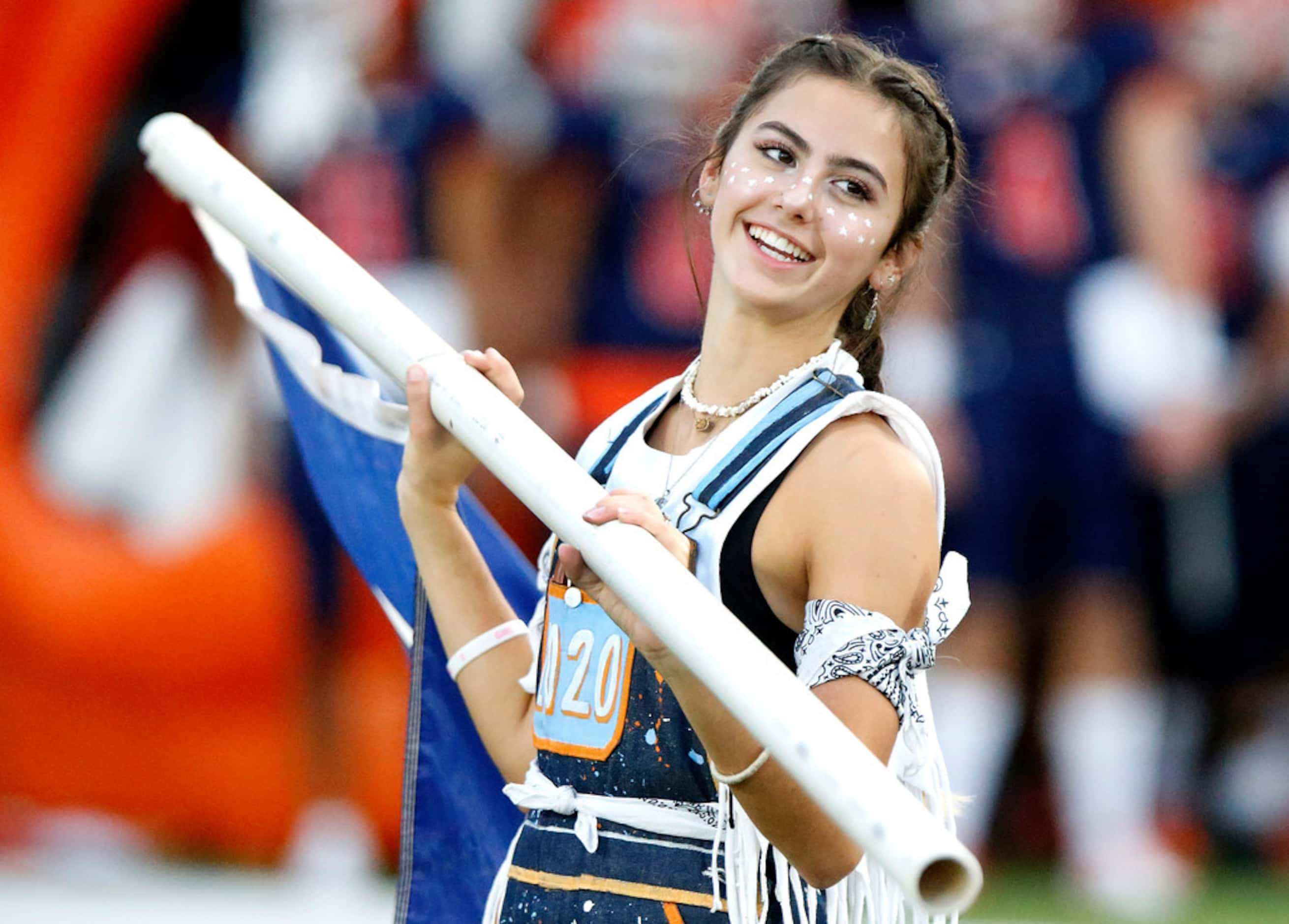 Tara Jones, 17, with the McKinney North High School Guard Dawgs spirit squad, readies a flag...