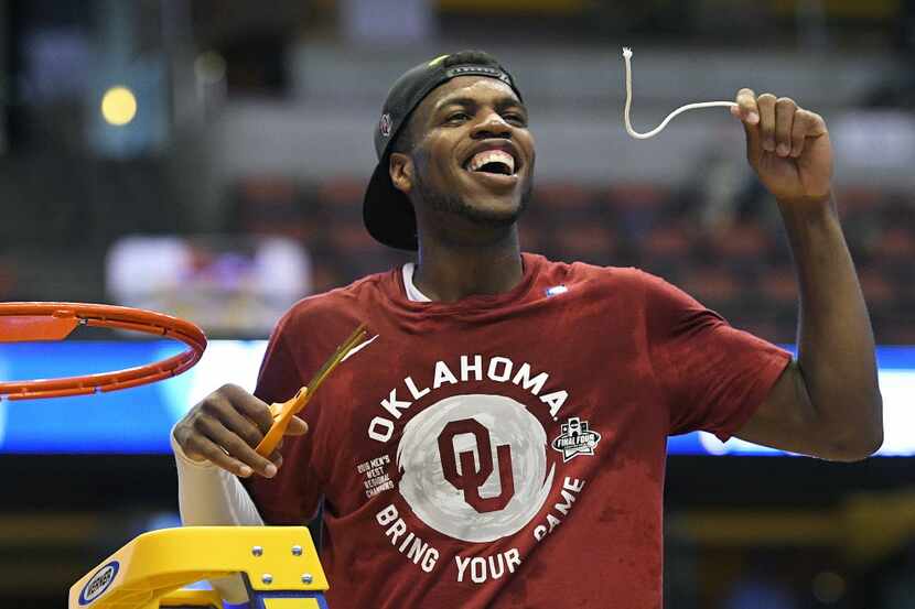 Oklahoma guard Buddy Hield cuts down the net after their win against Oregon during an NCAA...