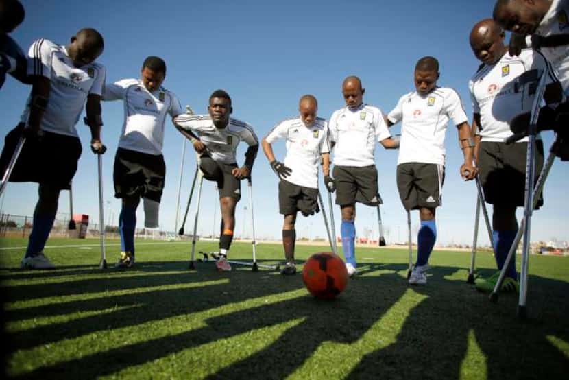 
The Haitian amputee soccer team prayed together before practice at Toyota Stadium. The team...