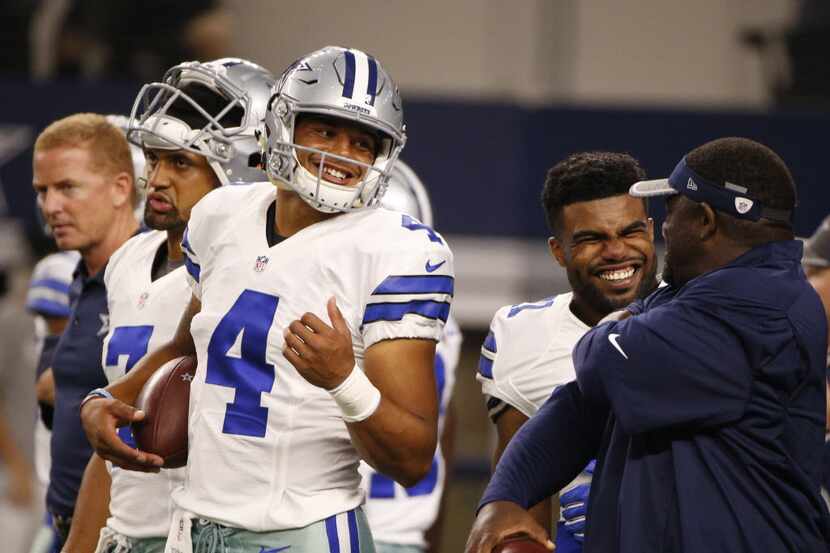 Dallas Cowboys quarterback Dak Prescott (4) jokes around before their game against the...