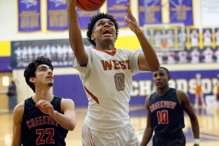 West Mesquite forward Mike Nweke (0) puts up a shot after  rebounding the ball against...