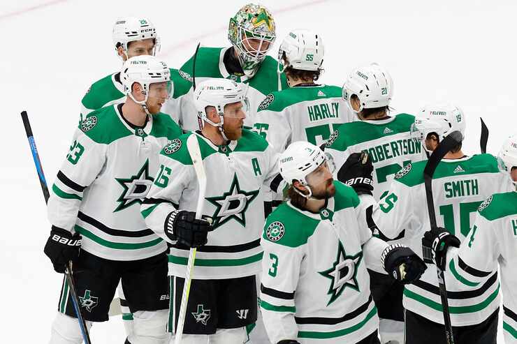Dallas Stars goaltender Jake Oettinger (29) celebrates with teammates after a 5-3 victory...