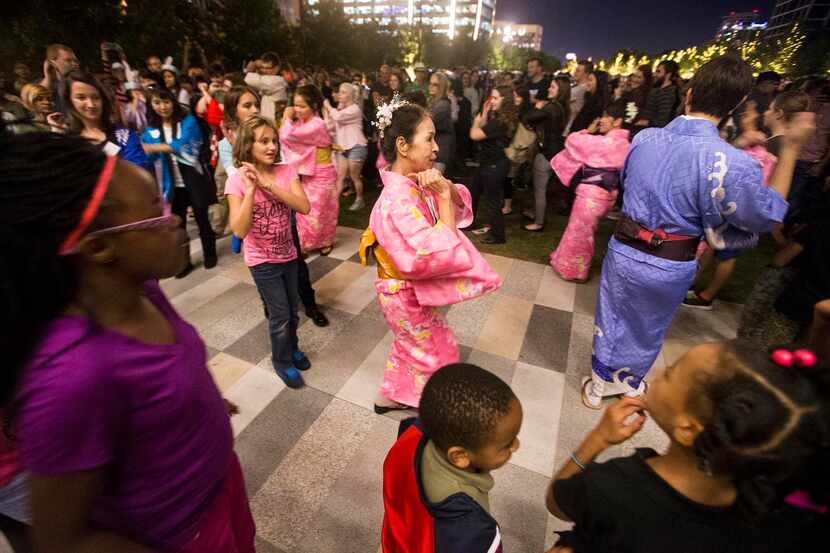 Right:  The Miyagi-Ryu Nosho-Kai dancers   led the crowd in the Bon Odori Dance during the...