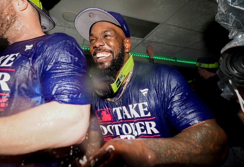 Texas Rangers right fielder Adolis García celebrates clinching a playoff spot in the...