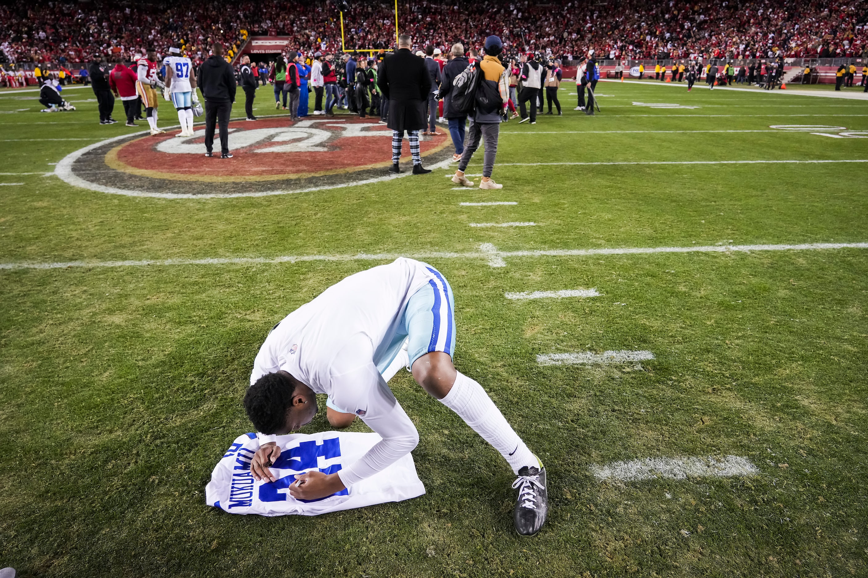 Dallas Cowboys safety Israel Mukuamu swaps jerseys after a loss to the San Francisco 49ers...