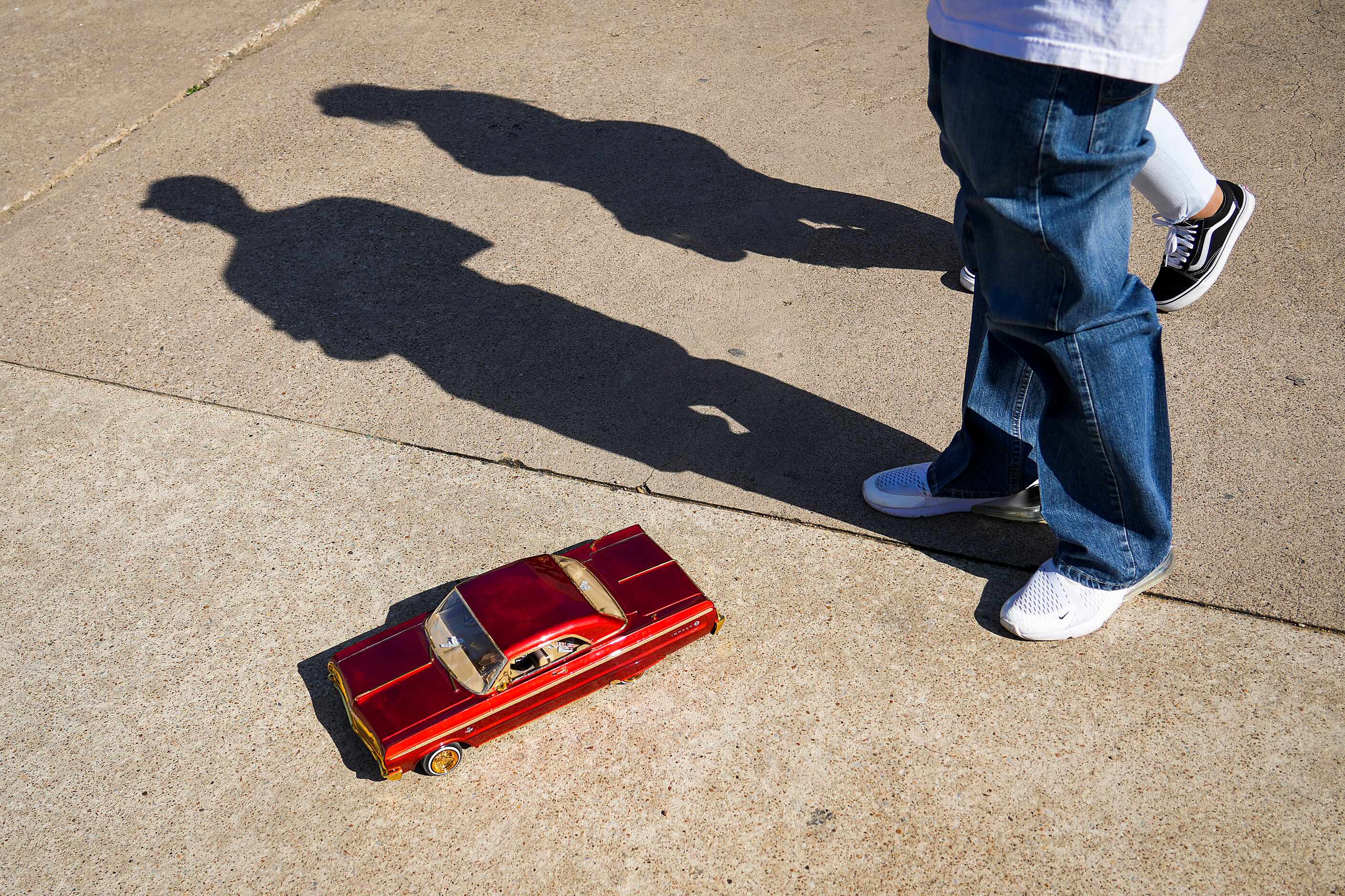 A man drives a radio controlled lowrider car through the grounds during the 214Selena...