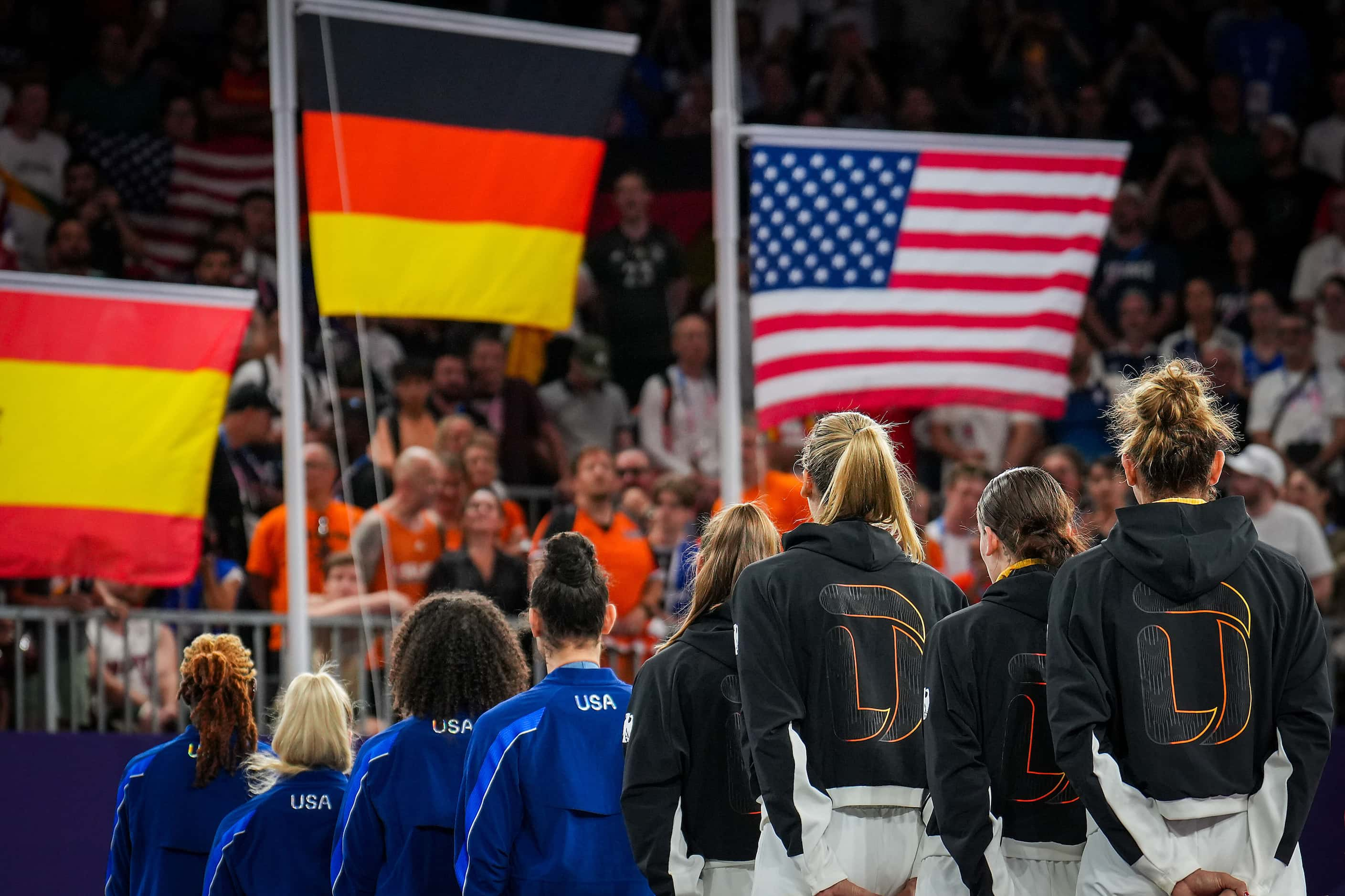 The flags of silver medalist Spain, gold medalist Germany and bronze medalist the United...