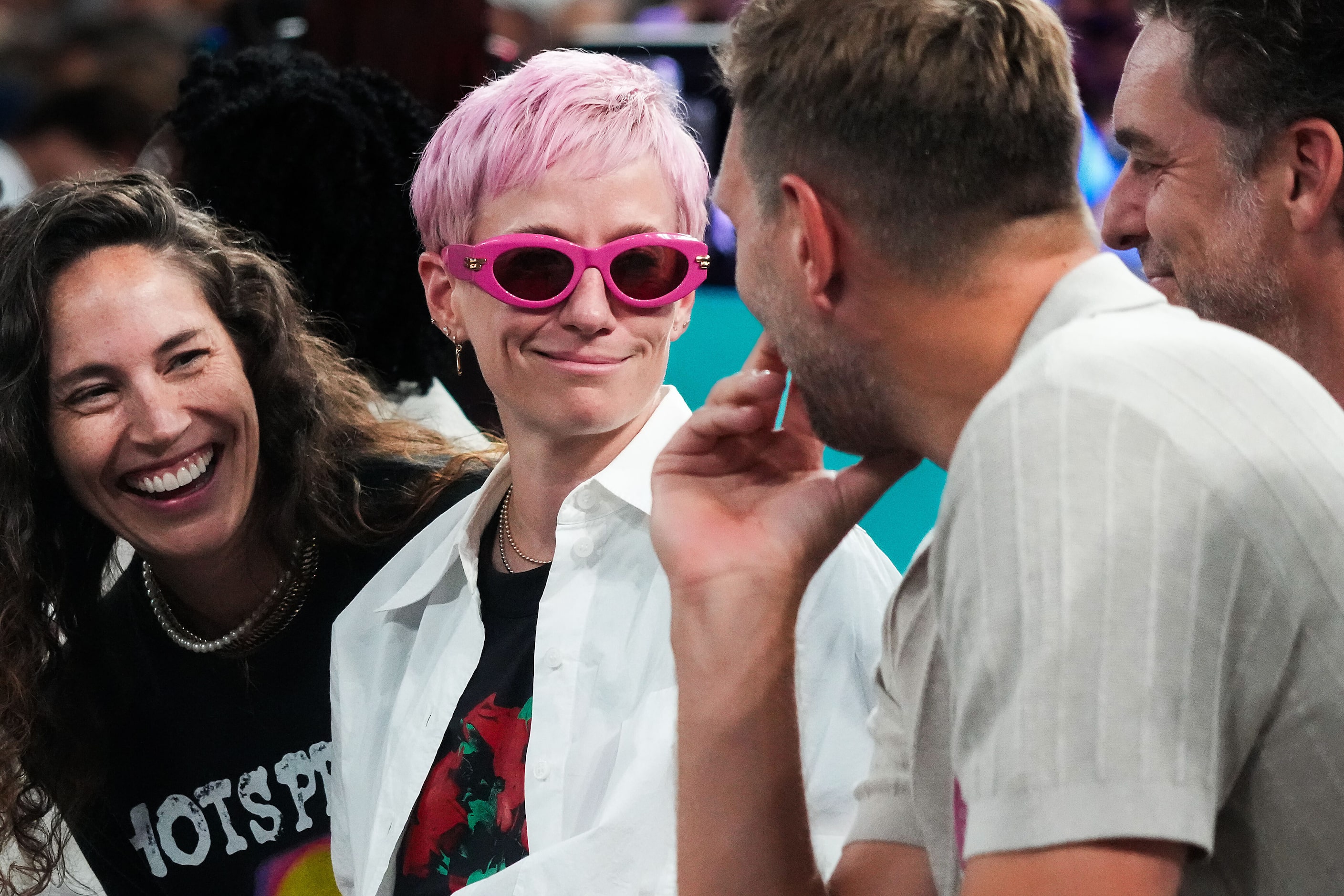 Megan Rapinoe and Sue Bird laugh with Dirk Nowitzki during the men's gold medal basketball...