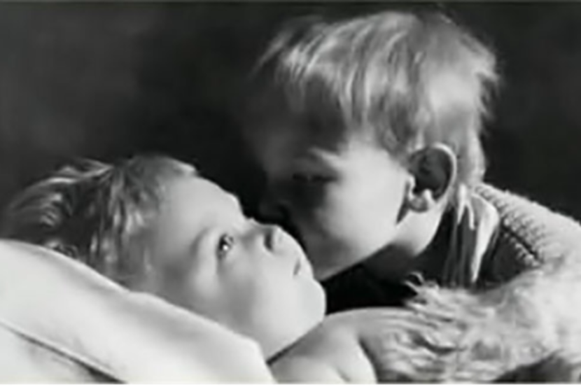 The author's brother Bruno kisses their brother Oliver, who was born with severe brain damage.