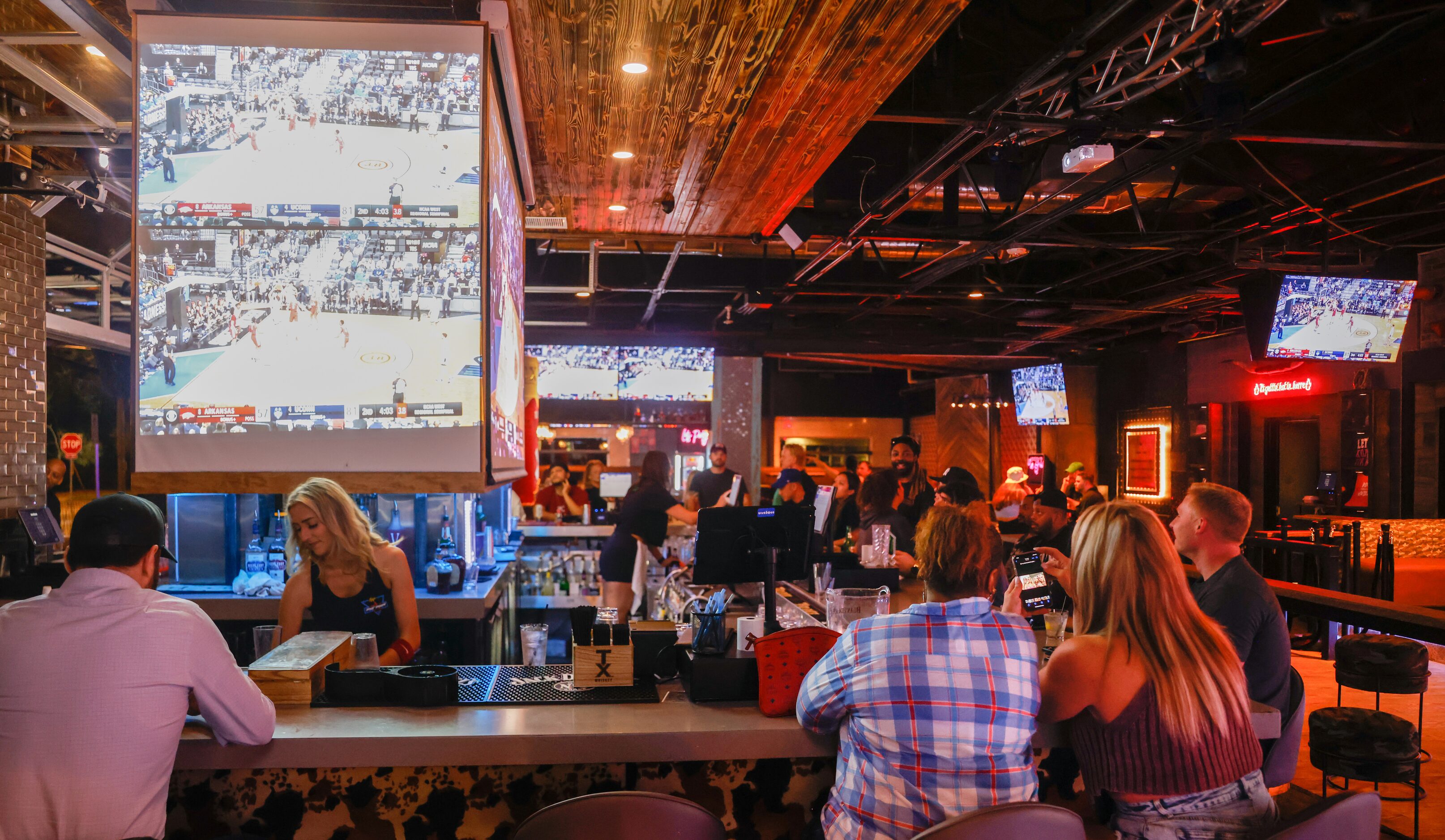 Guests line the bartop at Koe Wetzel’s Riot Room in Fort Worth on Thursday, March 23, 2023....