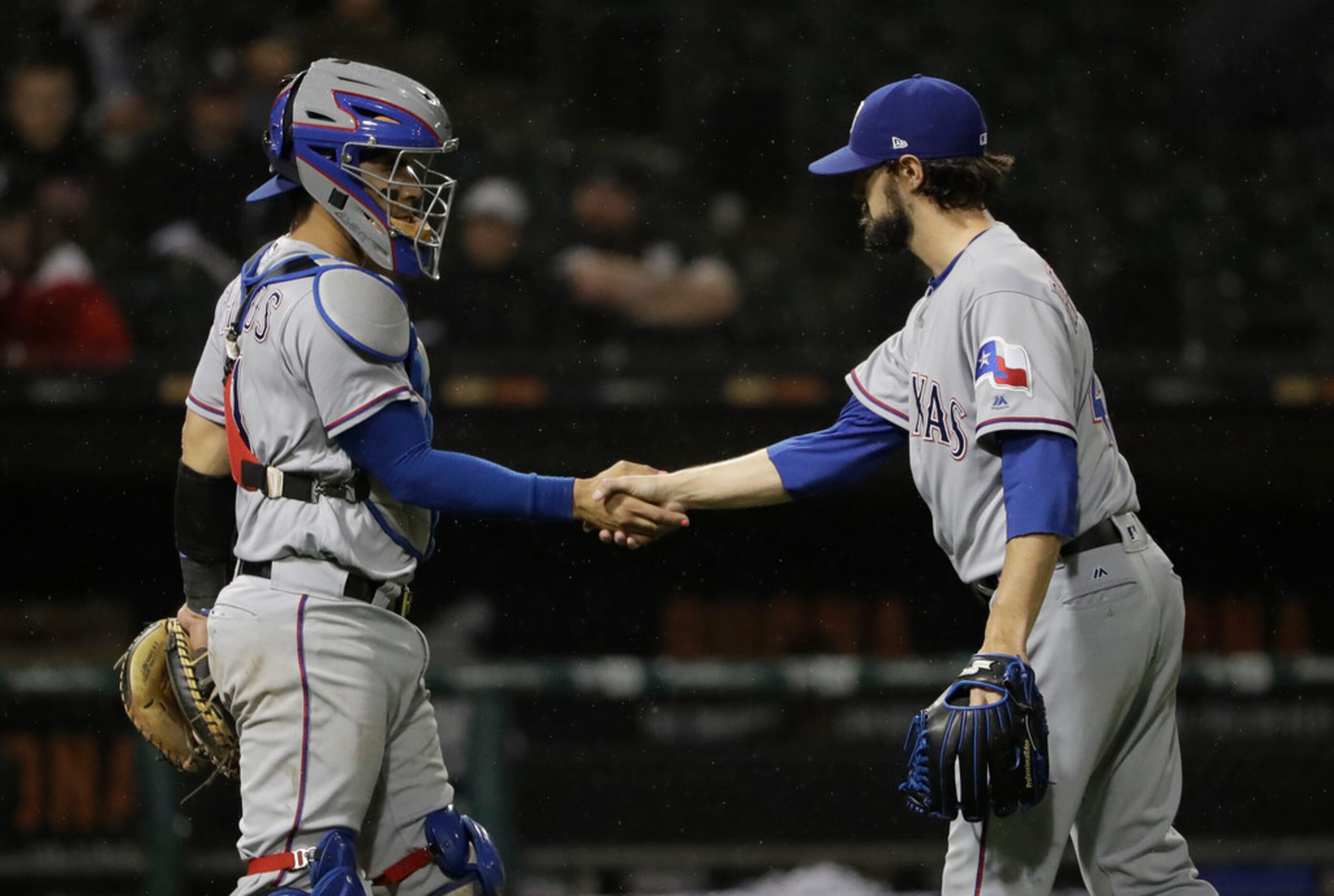 Texas Rangers relief pitcher Tony Barnette, right, celebrates with catcher Robinson Chirinos...