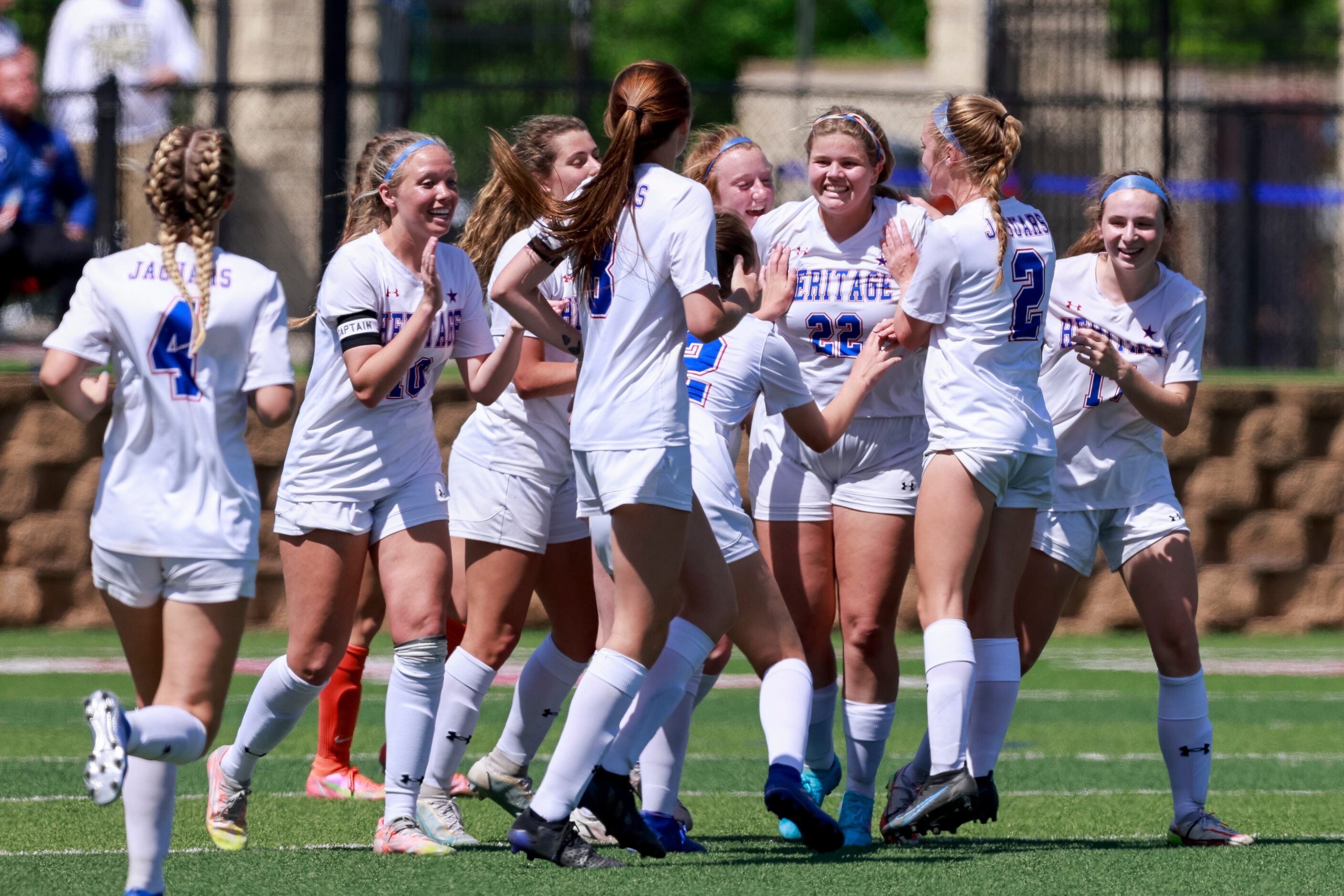 Midlothian Heritage midfielder Rose Giambruno-Fuge (22) is swarmed by teammates after...