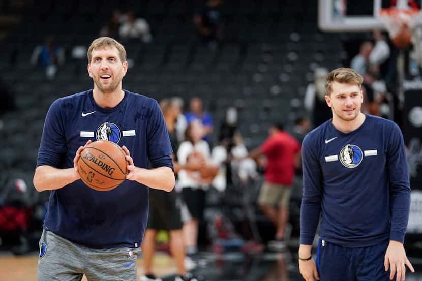 Dallas Mavericks' Dirk Nowitzki, left, and Luka Doncic warm up for the team's NBA basketball...