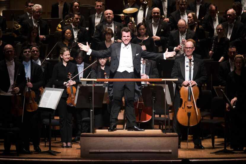 Guest Conductor Jakub Hrusa presents the orchestra for applause at the Dallas Symphony...
