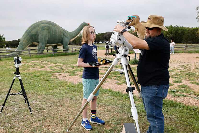 Fort Worth Astronomical Society member Christian Psencik of Fort Worth (right) set up an...