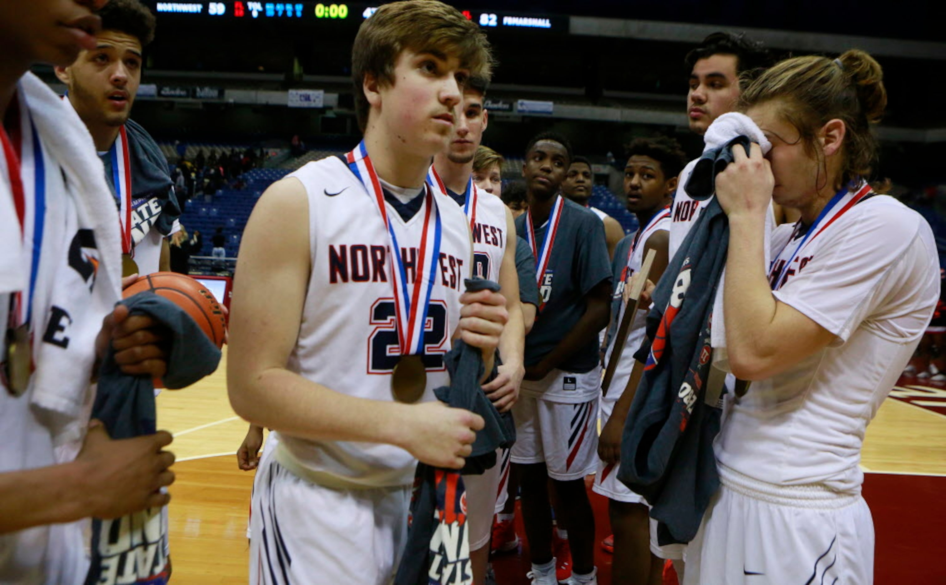 Justin Northwest's Christian Healer (22), center, exits the court with his team after...