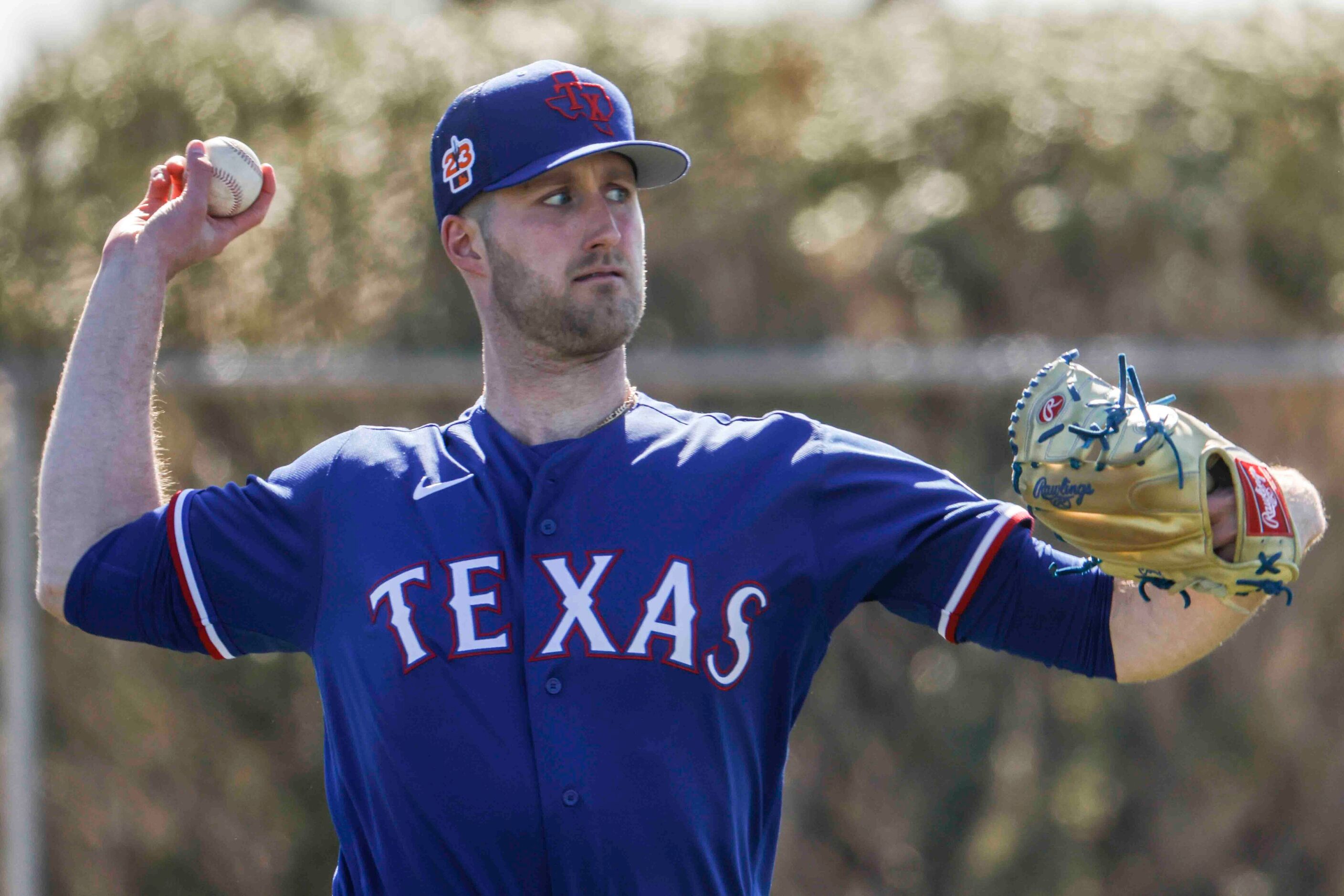 Texas Rangers right handed pitcher Kyle Cody participate in a drill during the first spring...