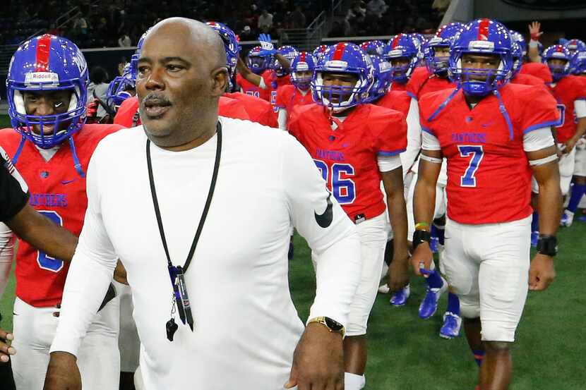 Duncanville head coach Reginald Samples leads his team to the handshake line after their...