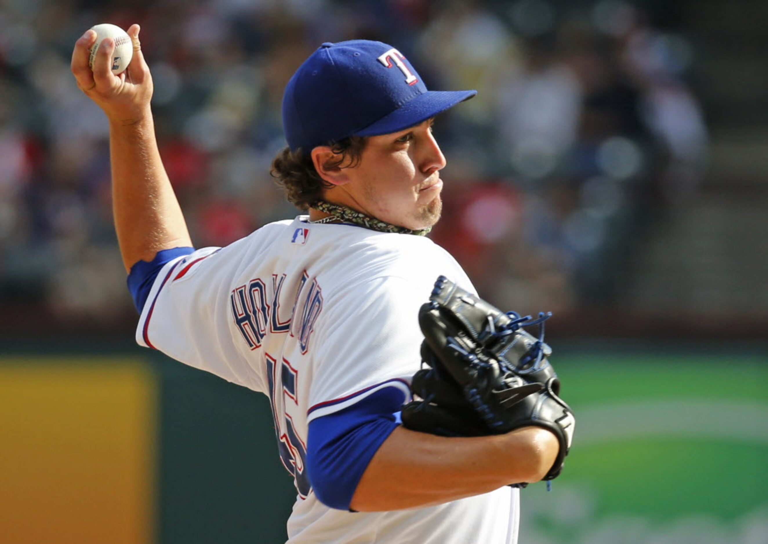 Texas pitcher Derek Holland throws a ninth-inning pitch during the Oakland Athletics vs. the...