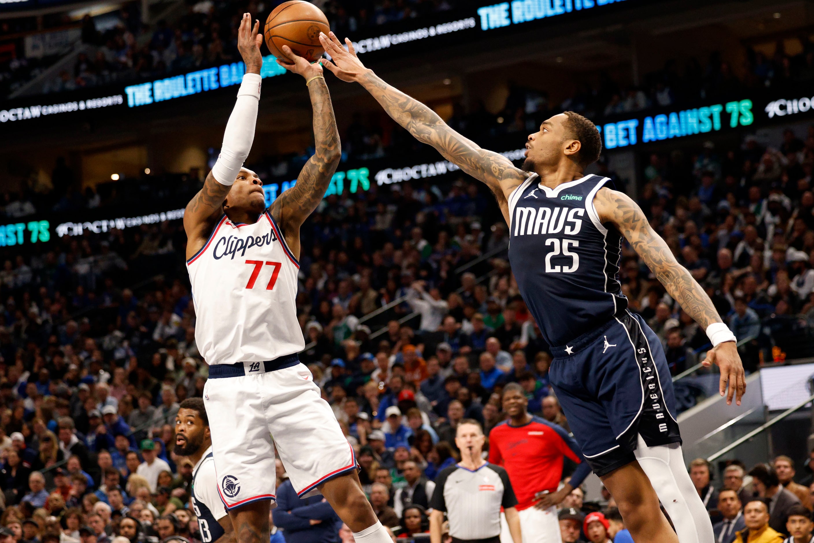 LA Clippers guard Kevin Porter Jr. (77) shoots as Dallas Mavericks forward P.J. Washington...