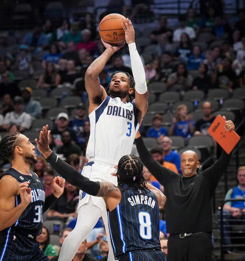 Dallas Mavericks guard Jaden Hardy (3) shoots over Orlando Magic guard Zavier Simpson (8)...