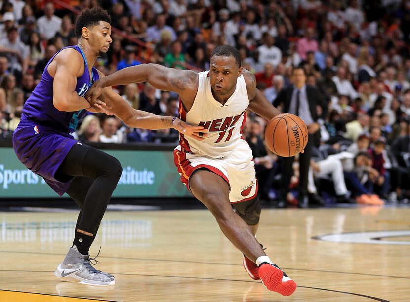 MIAMI, FL - OCTOBER 28:  Dion Waiters #11 of the Miami Heat drives on Jeremy Lamb #3 of the...