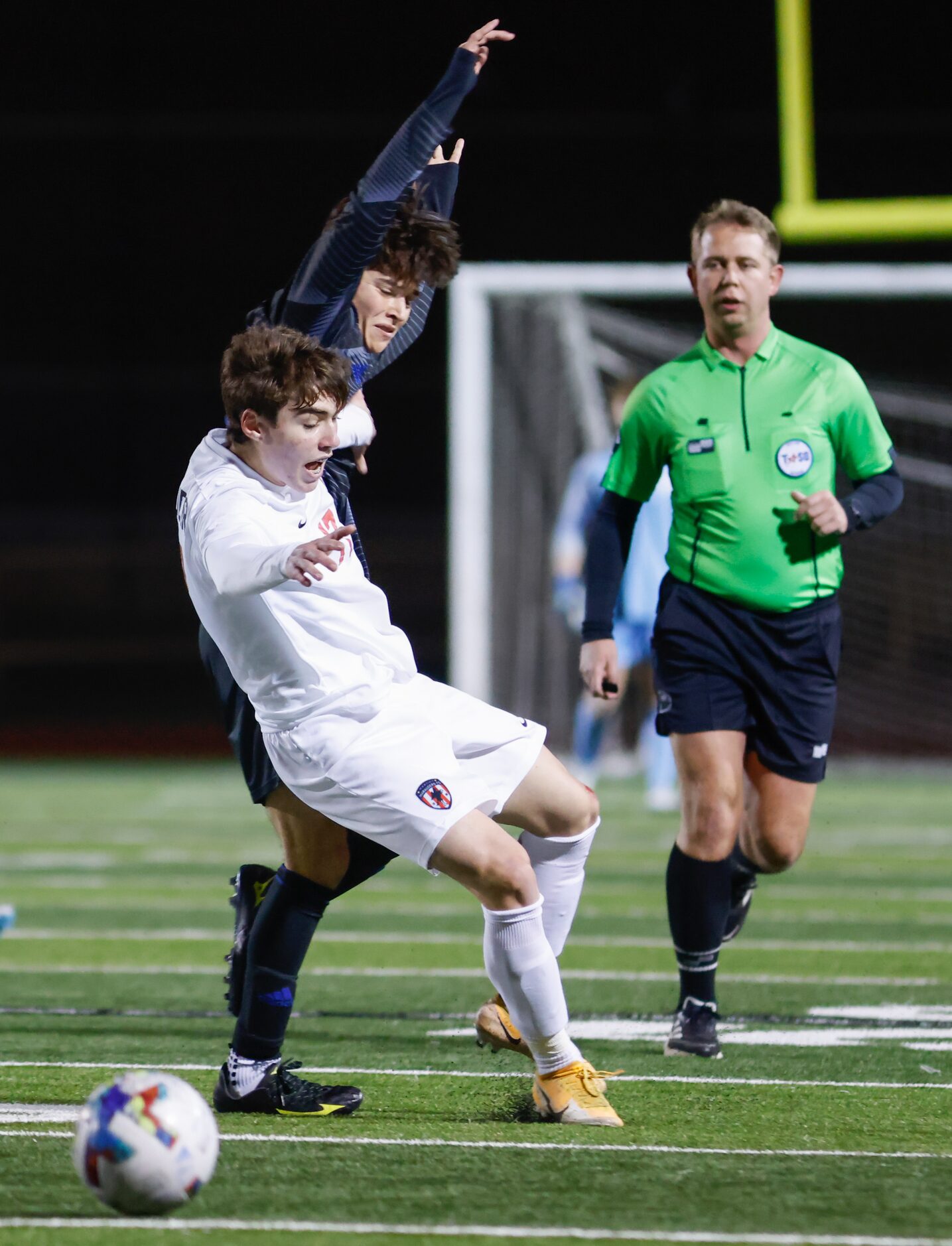 Flower Mound Marcus’ Artian Rifati (17) falls after attempting to gain control of the ball...