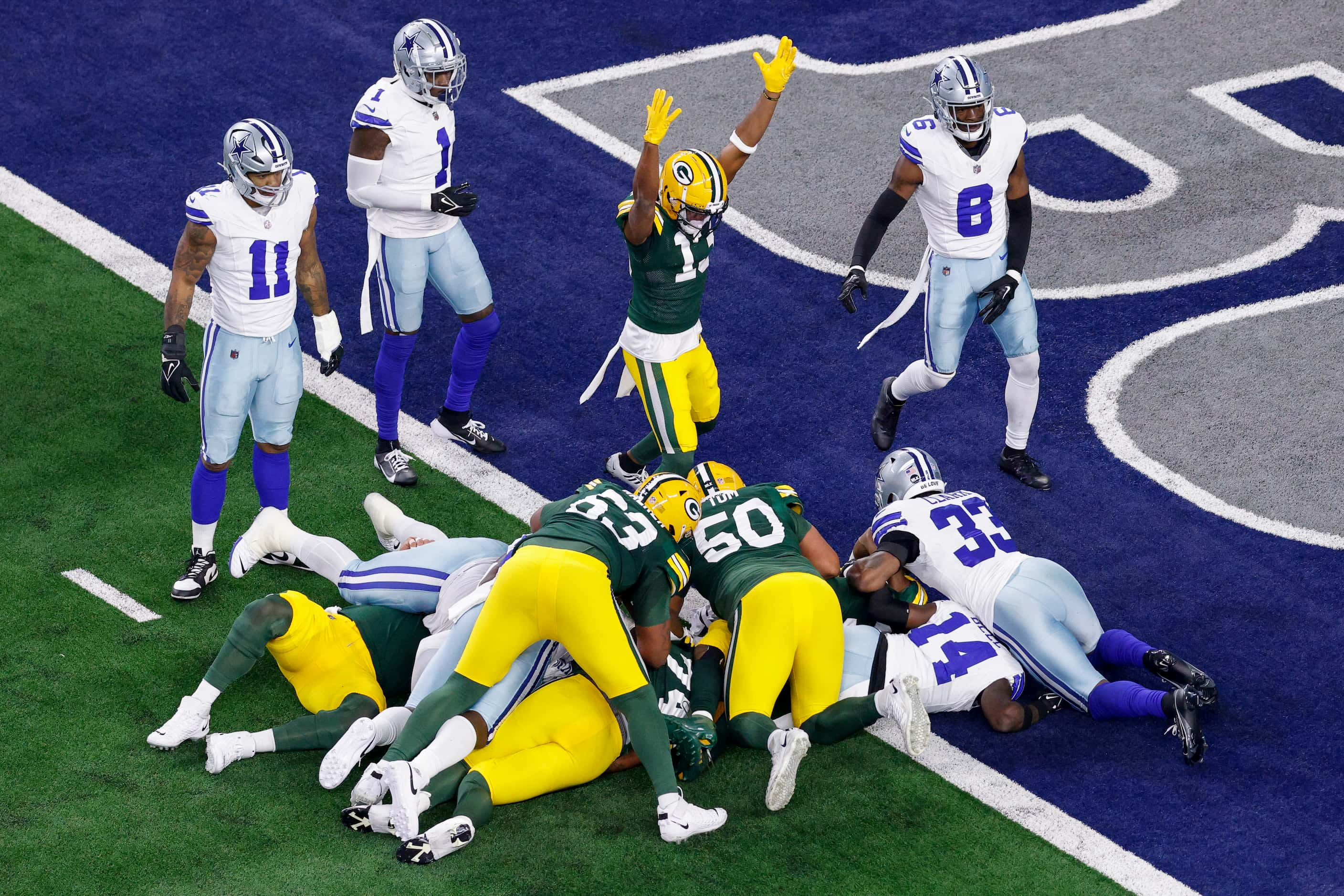 Green Bay Packers wide receiver Dontayvion Wicks (13) celebrates a touchdown by running back...