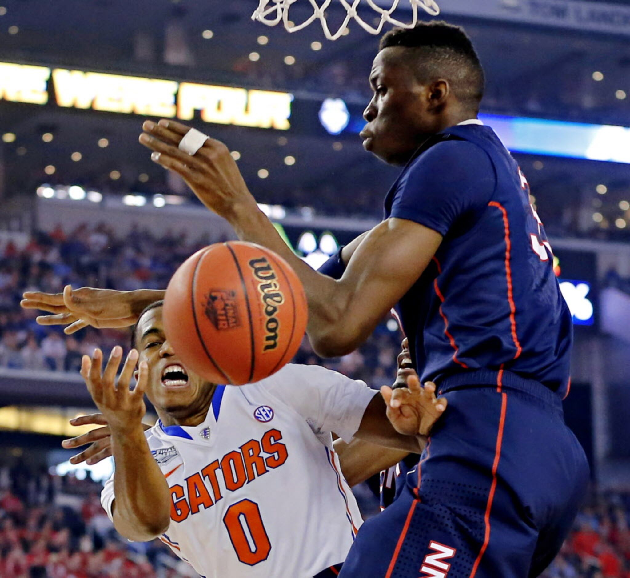 Florida Gators guard Kasey Hill (0) goes up against Connecticut Huskies center Amida Brimah...