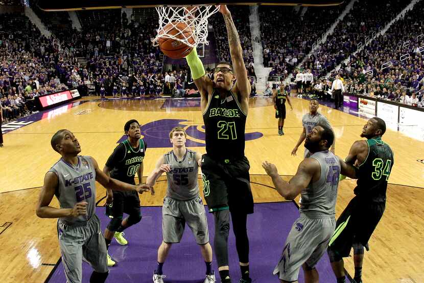 Baylor's Isaiah Austin (21) dunks during the first half of an NCAA college basketball game...