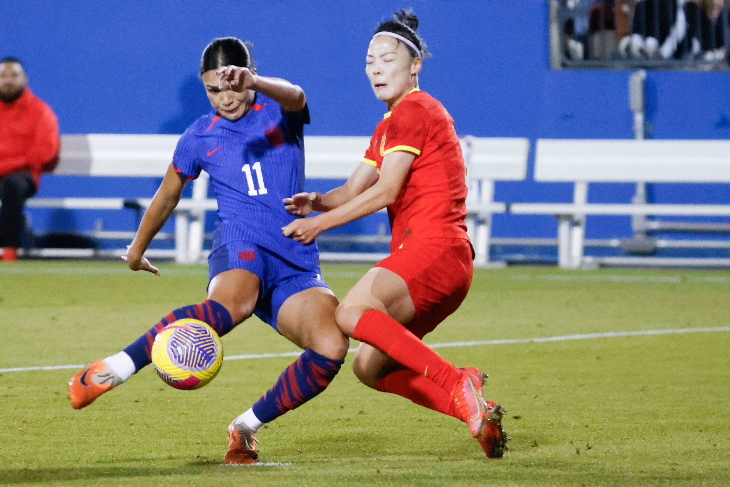 United States forward Sophia Smith (left) shoots past China defender Li Mengwen during the...